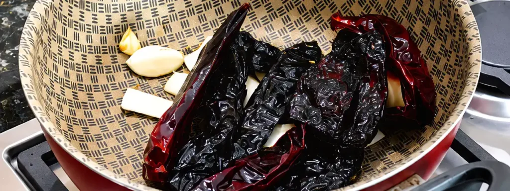 Chiles para adobo con ajo y cebolla dorándose