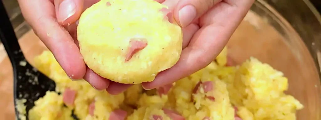 Formando tortitas de papa con salchicha y queso